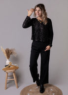 Combinaison pantalon palazzo noire haut sequins et dos nu 
